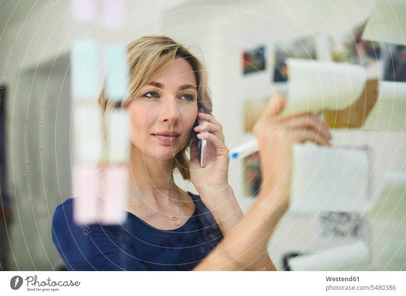 Porträt einer blonden Frau, die auf einen Notizblock schreibt und anruft Geschäftsfrau Geschäftsfrauen Businesswomen Businessfrauen Businesswoman Smartphone