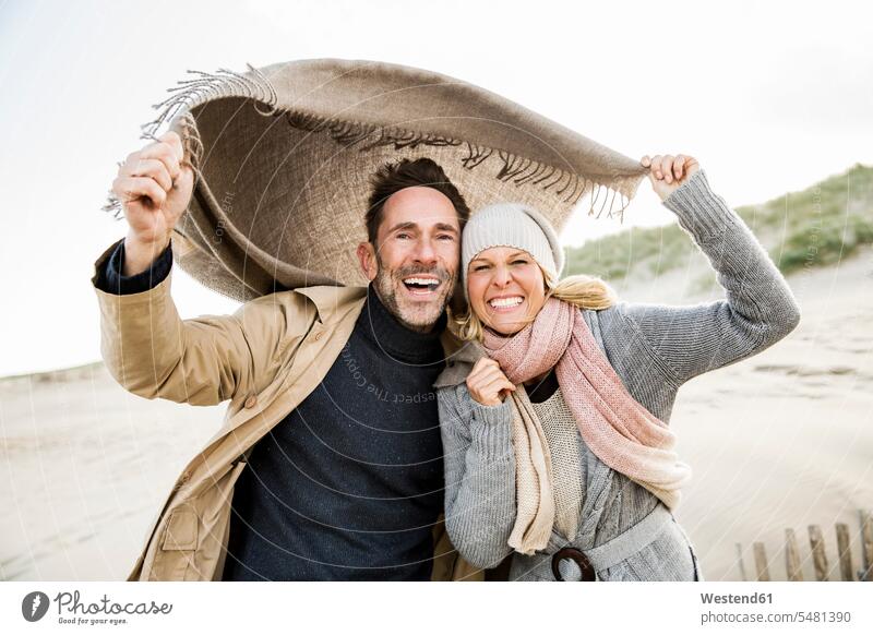 Porträt eines glücklichen Paares am Strand lachen Beach Straende Strände Beaches Pärchen Partnerschaft positiv Emotion Gefühl Empfindung Emotionen Gefühle