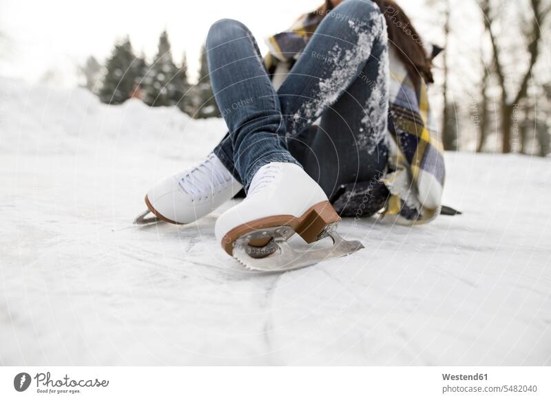 Frau mit Schlittschuhen auf Schnee liegend Schlittschuhlaufen Eislaufen weiblich Frauen Spaß Spass Späße spassig Spässe spaßig liegt Winter winterlich