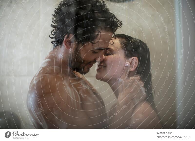 Intimes junges Paar unter der Dusche Pärchen Paare Partnerschaft Erotik Sexualität Duschen Mensch Menschen Leute People Personen einseifen lächeln berühren
