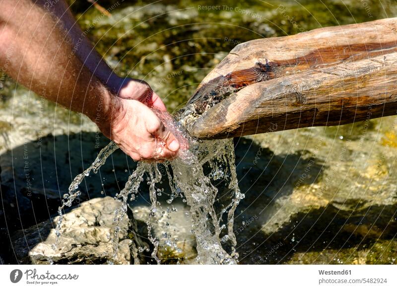 Männerhände trinken Wasser aus einer Quelle, Nahaufnahme Hand Hände Quellen Mensch Menschen Leute People Personen Gewässer Mann männlich Erwachsener erwachsen