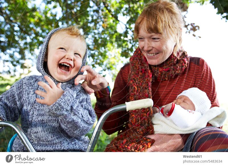 Glückliche Mutter mit Sohn und Baby in der Natur lachen Mami Mutti Mütter Mama Spaß Spass Späße spassig Spässe spaßig Kind Kinder Familie Familien Babies Babys
