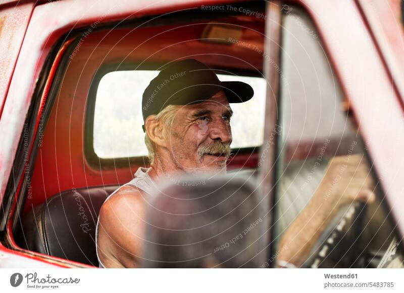 Älterer Mann fährt einen alten Pick-Up Pickup Senior ältere Männer älterer Mann Senioren fahren fahrend fahrender fahrendes männlich Kleinlastwagen Pick Ups