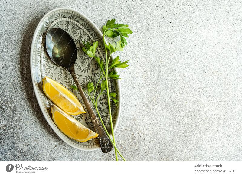 Mit nativem Olivenöl, Zitronenscheiben und grünem Petersilienkraut auf dem Teller anrichten Löffel Jungfrau Scheibe Kraut Speise dekoriert farbenfroh