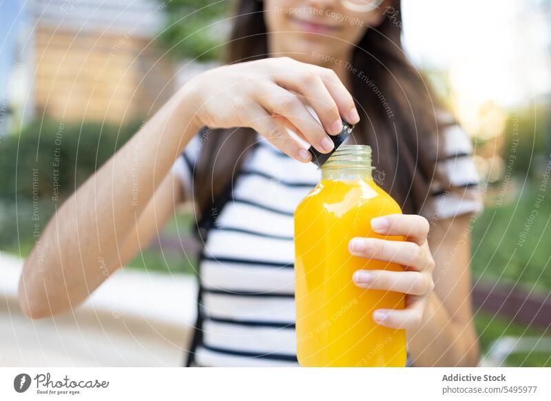 Unbekannte Frau mit Saftflasche Flasche Straße frisch offen trinken orange Getränk Erfrischung Lächeln Glück Durst Zitrusfrüchte geschmackvoll Freude froh