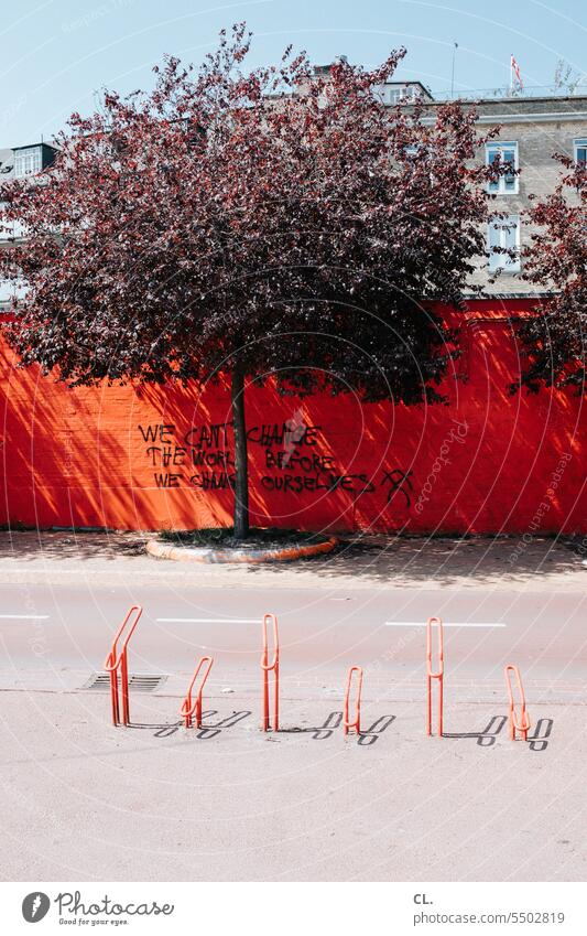 weltverbesserung Graffiti Redewendung Fahrradparkplatz Wand rot Kopenhagen Verkehr Mobilität Verkehrswende Verkehrswege Spruch Straßenverkehr Menschenleer