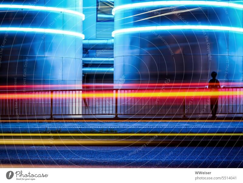 Die Leuchtröhren auf den Tanks und die Spuren von Autos und Autobus ergeben ein buntes Streifenmuster Licht Lichtstreifen Bewegung vorbeifahren Industrie Straße