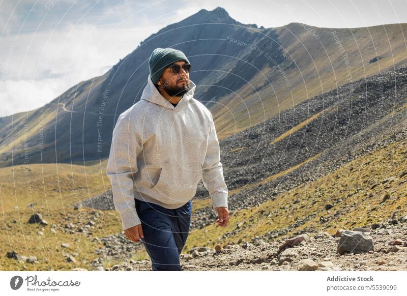 Junger Mann, der bei Tageslicht auf einer Bergklippe spazieren geht Wanderer Berge u. Gebirge Felsen Landschaft Abenteuer Tourist bewundern Vulkan Natur