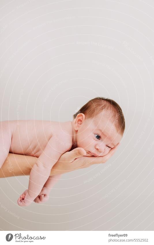 Ein Neugeborenes an der Hand seines Vaters gegen Weiß Baby neugeboren Erstgeborenes Porträt Verlegung Hinlegen Textfreiraum Elternschaft Mutterschaft Unschuld