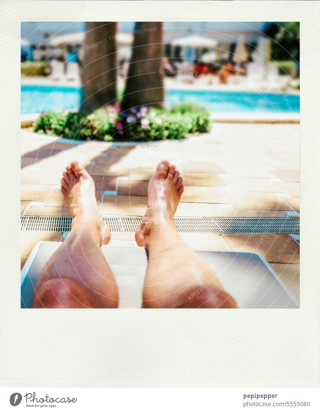 Wahrer Wohlstand – Füße hoch und das Leben genießen, so lange es noch geht! Mann mit sonnengebräunten Beinen am Hotelpool Pool Pools Urlaub Urlaubsstimmung