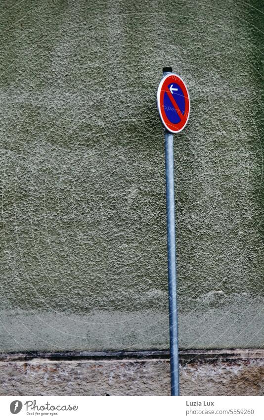 Eingeschränktes Halteverbotsschild vor einer graugrünen Hauswand, ein Spiel der Farben Schild Verkehrsschild eingeschränktes Halteverbot