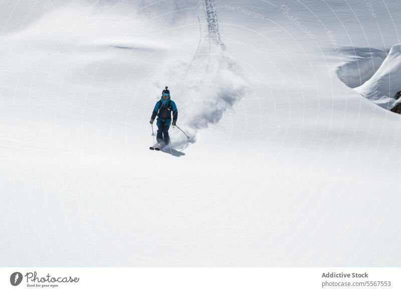 Person beim Skifahren auf einem schneebedeckten Berg im Urlaub unkenntlich Berge u. Gebirge Gerät Skifahrer verschneite wandern Natur Ganzkörper sonnig Winter