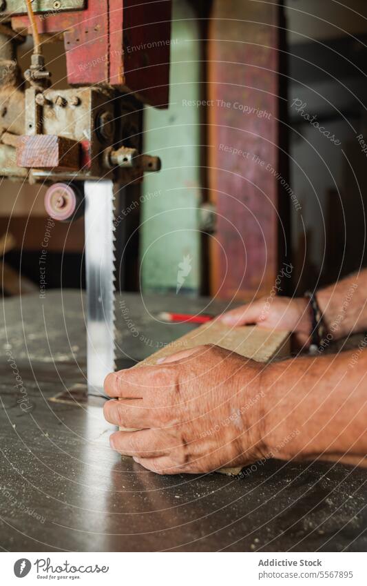 Anonyme Person, die in Toledo Holz durch eine Säge führt Hand älter Schreinerei Werkstatt Anleitung Nahaufnahme Schiffsplanken Fähigkeit Präzision Maschine