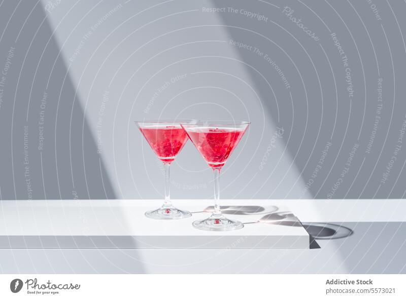Elegante Präsentation von Granatapfel-Cocktails Glas rot Garnierung Hintergrund Schatten grau pulsierend Getränk trinken elegant dekorativ Belag Silhouette