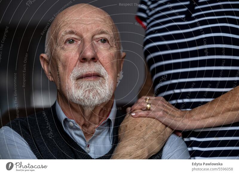 Porträt eines älteren Mannes mit seiner Betreuerin im Hintergrund echte Menschen Senior älterer Erwachsener reif männlich Kaukasier heimwärts Haus alt Alterung