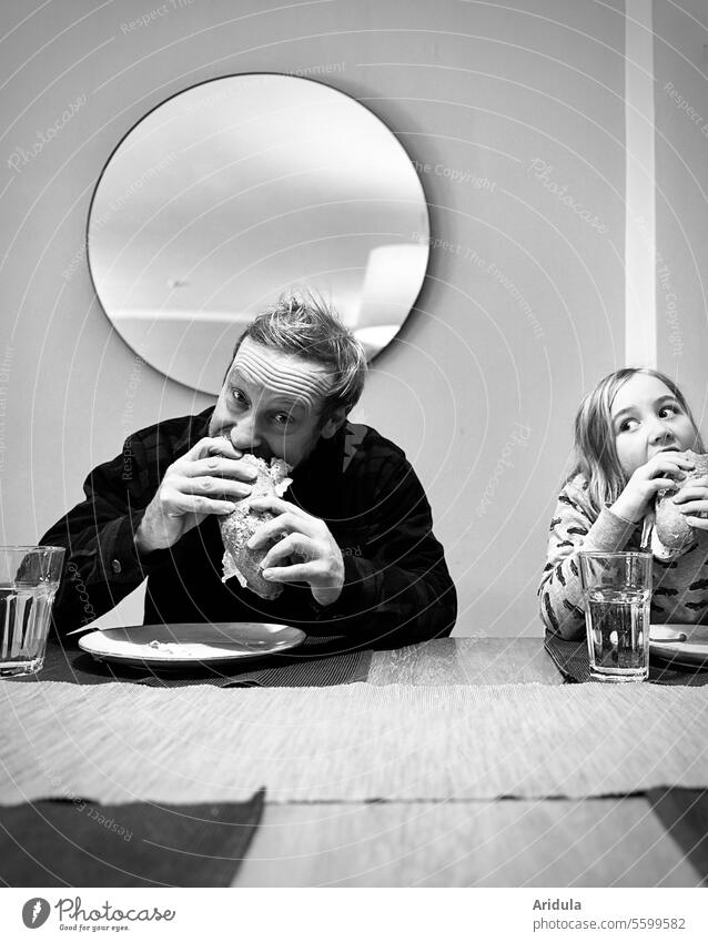 Mann und Kind essen einen Croque am Esstisch s/w Essen Baguette Brot lecker Mund Augen hunger Blick Appetit & Hunger Ernährung Belegtes Brot Innenaufnahme Tisch