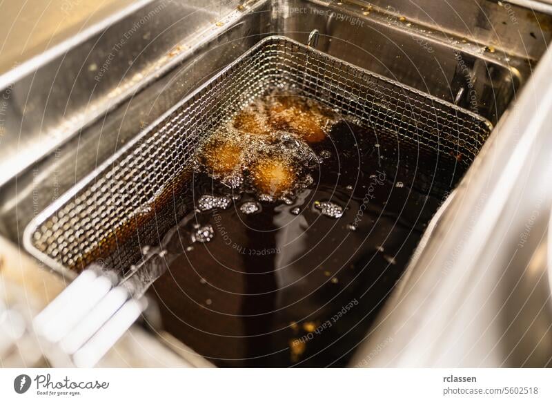 Frittierte Kartoffelbällchen frittiert in Frittierfett in einer Großküche eines Restaurants. Luxus-Hotel Kochen Konzept Bild. lecker Food-Styling