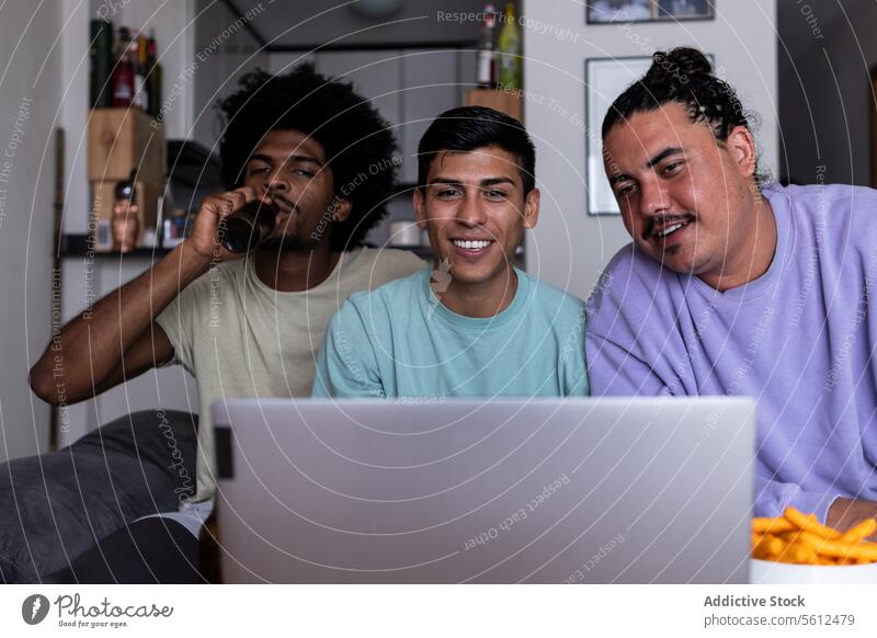 Videoanrufe mit Freunden auf dem Laptop zu Hause Lächeln Anruf Lifestyle Wohnzimmer heiter Freizeitkleidung Drahtlos Computer Afrohaar Gerät online