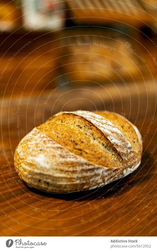 Nahaufnahme eines frisch gebackenen leckeren Brotes mit knuspriger Kruste auf einem Holztisch in der Küche einer Bäckerei Brotlaib Knusprig Tisch hölzern
