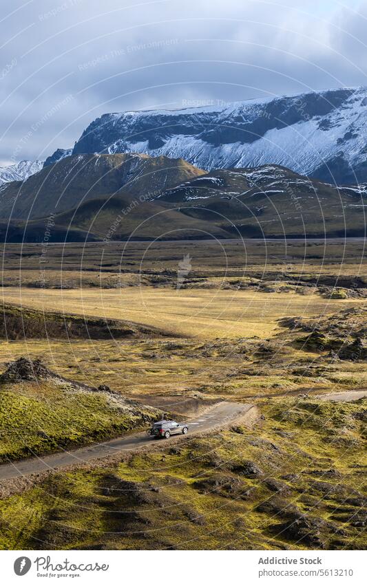 Von oben von einem einsamen Geländewagen auf der Straße im isländischen Hochland in Thorsmork gegen Berge an einem bewölkten Tag Island Tal Berge u. Gebirge