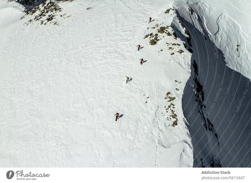 Menschen Snowboarding auf verschneiten Berg Mitfahrgelegenheit schneebedeckt Berge u. Gebirge Luftaufnahme unkenntlich Menschengruppe Snowboarder Schnee