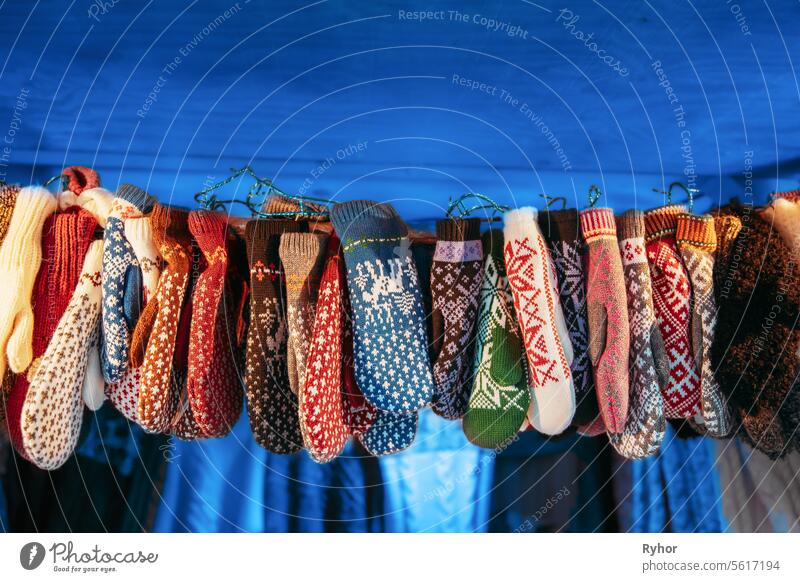 Verschiedene Multicolored Mittens und Handschuhe. Handgefertigte gestrickte traditionelle europäische warme Kleidung - Fäustlinge auf dem Winter-Weihnachtsmarkt. Souvenir aus Europa. Hand Crafted Warm Clothes In Weihnachtsgeschäft