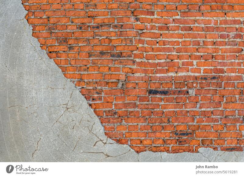 alte schlechte Backsteinmauer mit Resten von grauem, abgeschältem, dickem, sandigem Putz Hintergrund Wand Baustein angefressen rot verputzen Klotz Textur