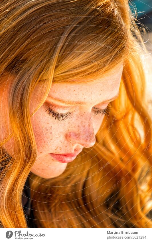 Schöne rothaarige junge Frau schaut nach unten lange Haare Kaukasier Sommersprossen Menschliches Gesicht Porträt schön Glück Schönheit Menschen abschließen