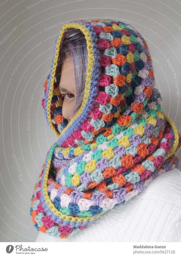 Person, die aus einem mehrfarbigen gehäkelten Schal herausschaut häkeln handgefertigt gemütlich warm Wärme Guck mal, farbenfroh Farbe Porträt