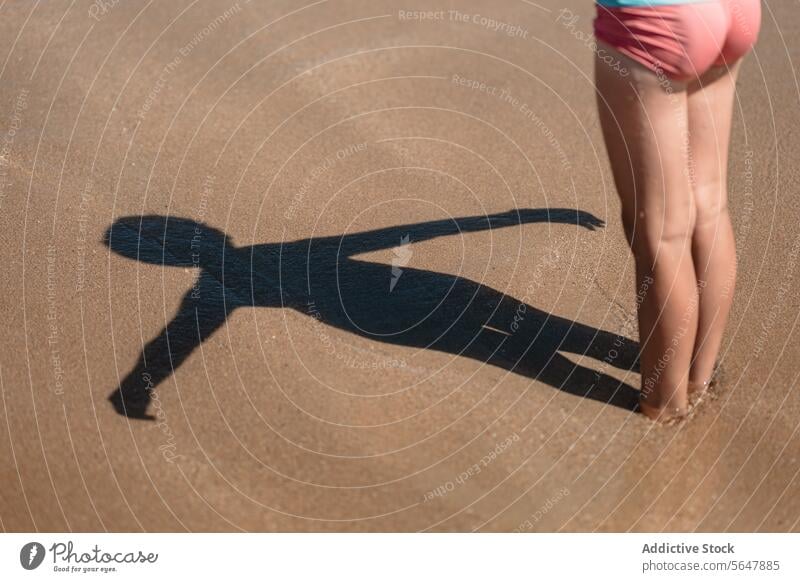 Schatten eines Kindes am Strand sandig Nahaufnahme Unterkörper anonym Sommer Abenteuer aktiv Lifestyle im Freien Neoprenanzug Sand Hobby entspannend Aktivität