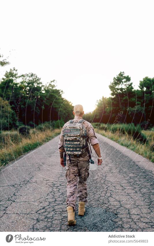 Ganzer Körper von unerkennbaren Mature commando zu Fuß auf der Straße bei Sonnenuntergang Mann Soldat laufen Tarnung Uniform Kommando speziell Militär Krieger