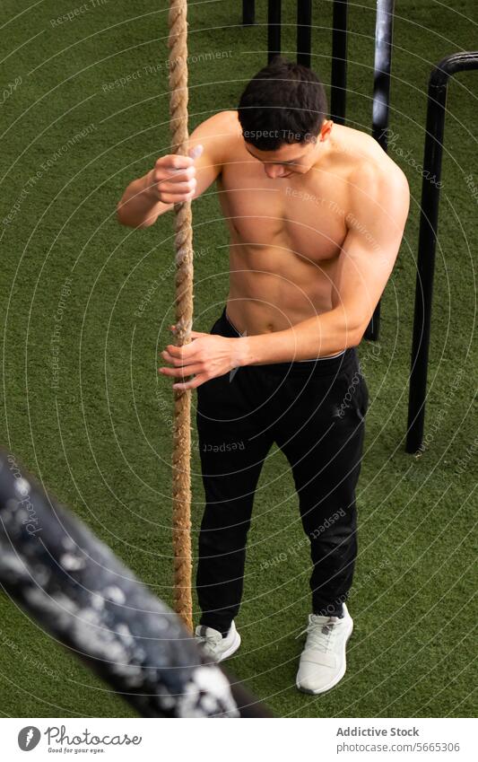 Hemdsärmeliger Sportler, der das Seil vor dem Calisthenics-Workout einstellt Aufstieg vorbereiten Übung calisthenics Training Gesunder Lebensstil Sportpark Mann