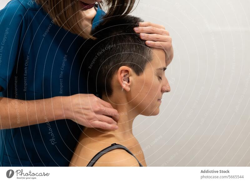 Physiotherapeutin bei der Nackenmassage eines Patienten geduldig Therapie Behandlung medizinisch professionell bürstet blau Frau Kurze Haare manuell berühren