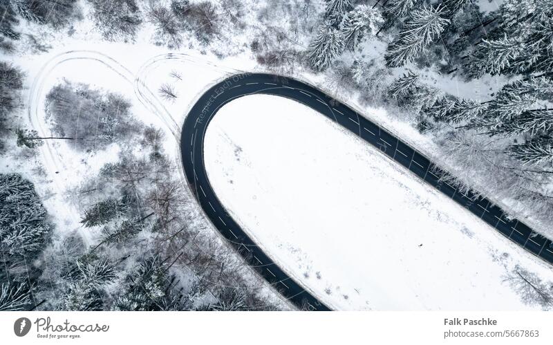 Winter Wonderland Luftaufnahme: Verschneite Straßen per Drohne eingefangen oben Abenteuer Luftbildfotografie Luftstraße Winter in der Luft Asphalt Hintergrund