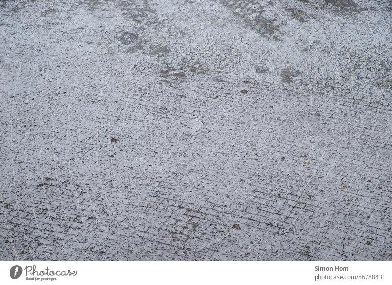 Eine gepflasterte Außenfläche, die mit einer Eisschicht überzogen ist vereist glatt Glätte kalt gefroren Winter frieren Eisfläche Strukturen & Formen Frost