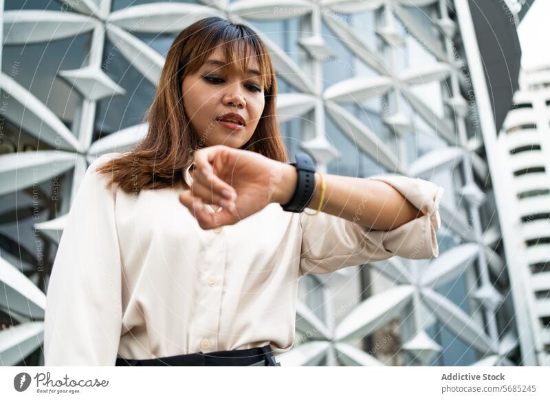 Überprüfung der Uhrzeit während eines geschäftigen Tages in Chiang Mai Frau asiatisch Thai Geschäftsfrau Thailand Großstadt urban modern Architektur Zeit