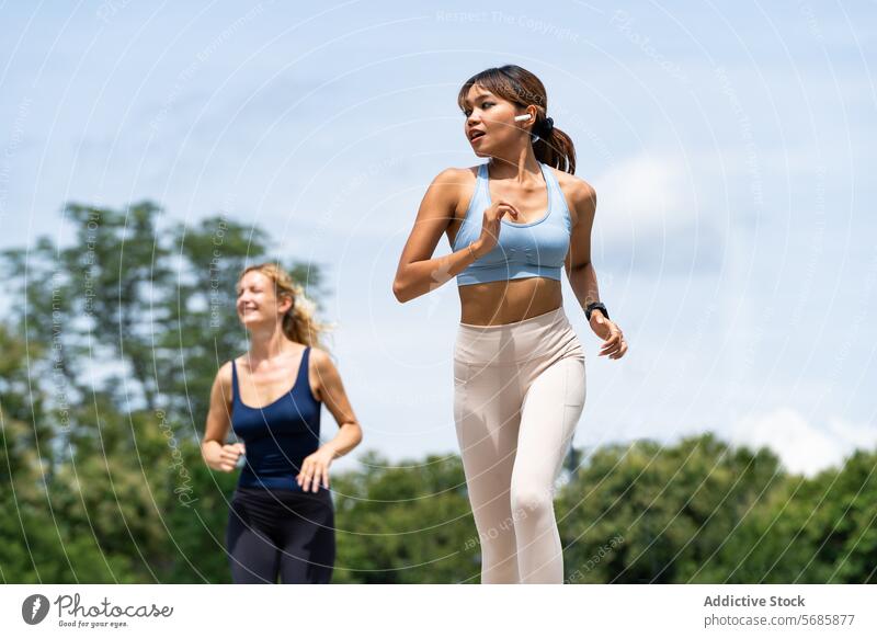Glückliche Sportlerinnen joggen auf der Straße Frauen Training Herz Sportkleidung Lächeln Turnschuh positiv Fitness Gesundheit Athlet Zusammensein