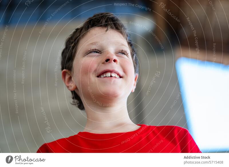Fröhlicher Junge bei einer Sportveranstaltung am Wochenende Kind Freude Fröhlichkeit rotes Hemd Lächeln heiter Überschwänglich Sportwochenende Jugend Emotion