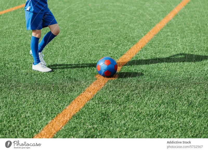Fußballspieler steht neben dem Ball an der Feldlinie Spieler Linie Rasen grün Sport Gras künstlich abgeschnitten blau farbenfroh Ausrüstung Schuhe Klampe