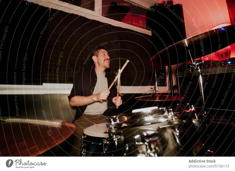 Schlagzeuger, der in einer Band spielt und von der Kamera wegschaut Mann männlich Trommelschlegel Leistung Spielen Becken Musik Instrument Wegsehen