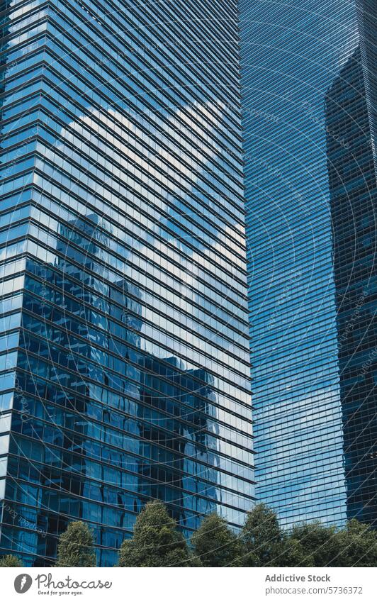Moderne Wolkenkratzer mit spiegelnden Glasfassaden Architektur Gebäude Fassade reflektierend modern urban Großstadt Hochhaus Turm Büro blau Himmel korporativ