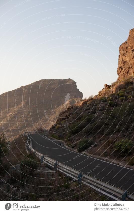 Kurvenreiche Straße in den Bergen mit Blick auf Fels- und Berggipfel bei bewölktem Wetter auf der Insel Gran Canaria Serpentinen Abenteuer Autoreise reisen