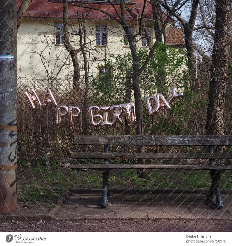 Happy Birthday Girlande hängt leicht lädiert über einer Parkbank geburtstag Geburtstagsfeier Party girlande Dekoration Berlin Großstadt Tradition tragisch schön