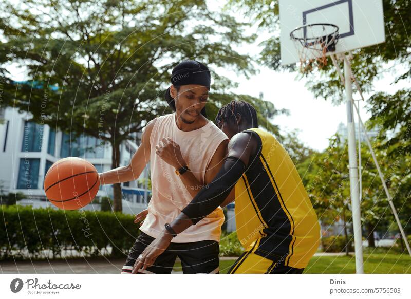 Black men playing streetball on outdoor court basketball game friend defend attack hit sport sportsman athlete Black man African American people male active