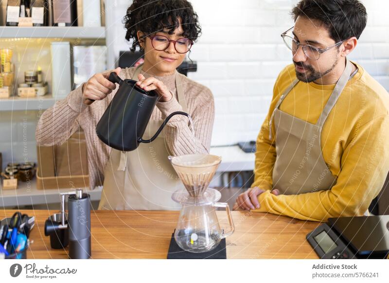 Multiethnische Baristas bereiten Pour-over-Kaffee in einem gemütlichen Café zu Gießkanne Teamwork Brauen multiethnisch Fähigkeit einladend warm Vorbereitung