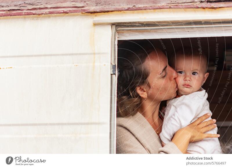 Van-Life-Familienmoment mit Mutter, die ihr Baby küsst Van Leben Kuss Zuneigung Wohnmobil Lifestyle nomadisierend Bonden Liebe Einfachheit Minimalismus