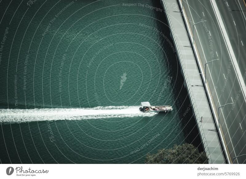 Ein Motorboot fährt mit hoher Geschwindigkeit auf eine Autobahn Brücke zu, unter der er  durch fahren will. Boot fahren Wasserfahrzeug Ferien & Urlaub & Reisen
