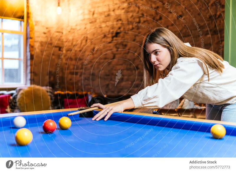 Junge Frau spielt in der Freizeit mit Freunden Billard jung Pool Spiel im Innenbereich Erholung spielerisch Tisch blau Ball Stichwort zielen Konzentration Fokus
