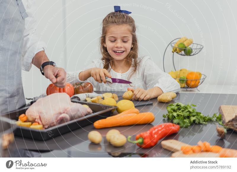 Eine Familie beim gemeinsamen Kochen in der Küche Essen zubereiten Gebratenes Huhn Gemüse Vorbereitung Bonden Kind Gesundheit Lebensmittel Mahlzeit