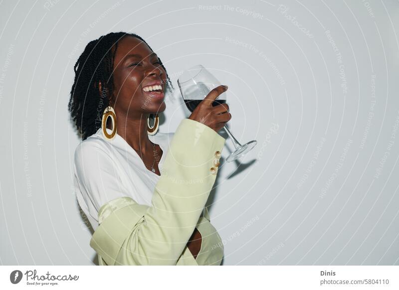 Portrait of joyful Black woman drinking wine at office party fun frieday drunk laugh portrait celebrate friday businesswoman workplace alcohol positive smile